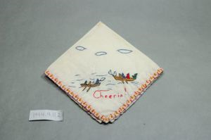 Image of Figures in vessels in ocean holding flags with the word "Cheerio!" below, one of a set of 3 embroidered napkins, each with different scene and title